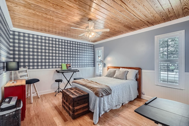 bedroom with ceiling fan, light hardwood / wood-style flooring, wooden ceiling, and ornamental molding