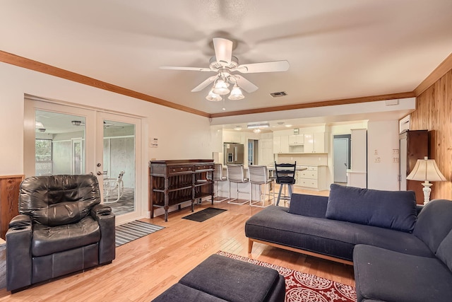 kitchen featuring white cabinets, light wood-type flooring, stainless steel appliances, and a breakfast bar area