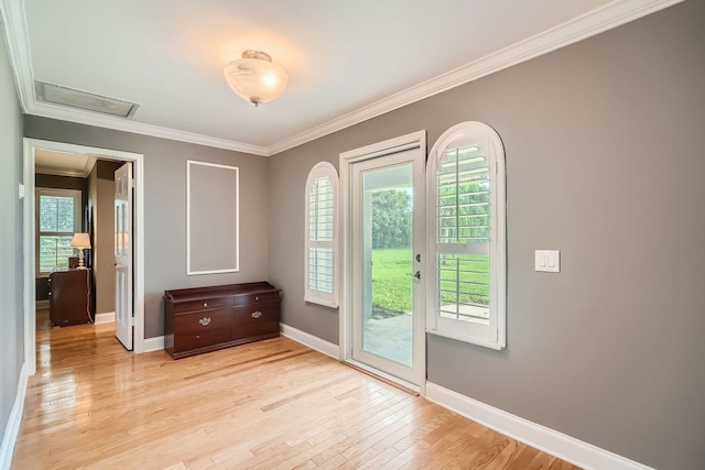 entryway with light hardwood / wood-style flooring and ornamental molding