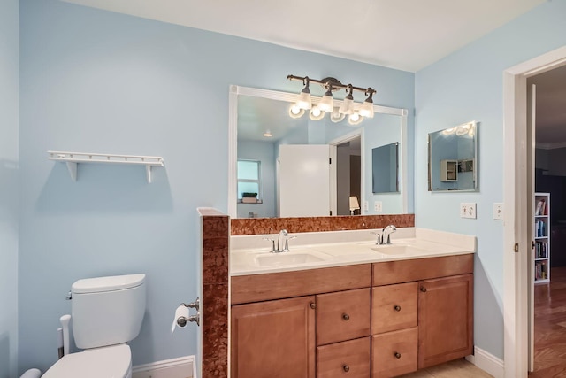 bathroom with hardwood / wood-style floors, vanity, and toilet