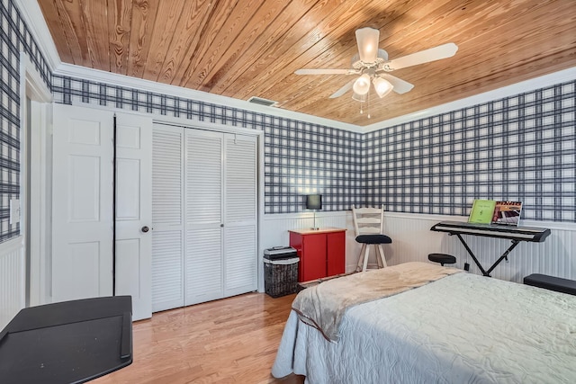 bedroom with wood-type flooring, a closet, ceiling fan, and wood ceiling