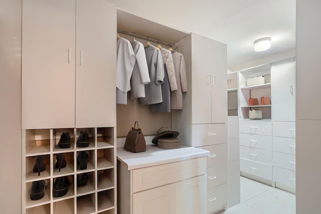 spacious closet with light tile patterned floors