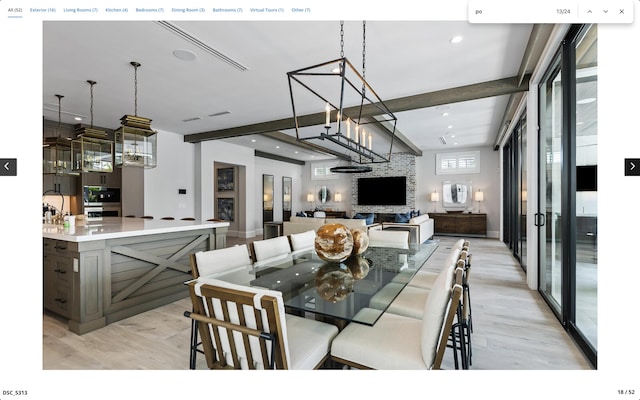 dining room featuring light wood-style flooring, a notable chandelier, and beam ceiling