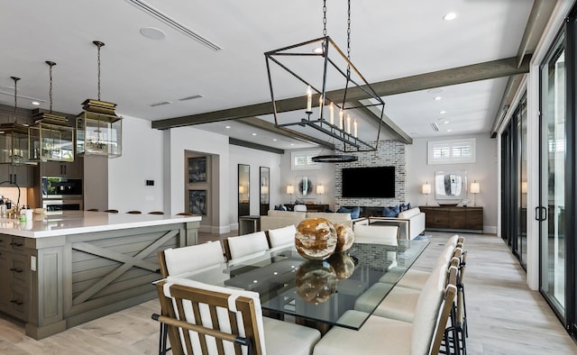dining room featuring an inviting chandelier, light wood-style flooring, beam ceiling, and recessed lighting