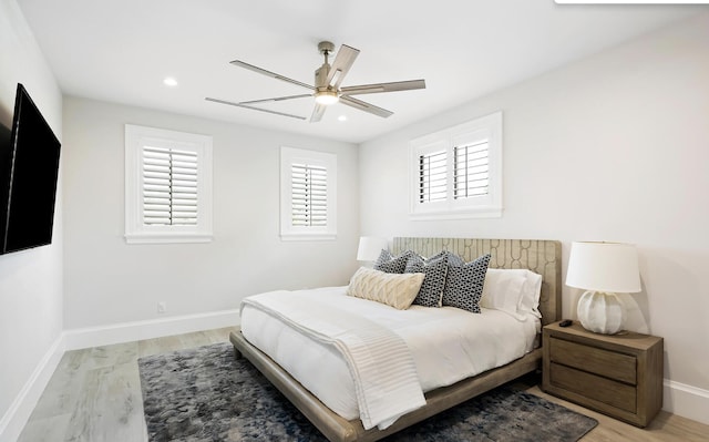 bedroom with baseboards, light wood-style flooring, ceiling fan, and recessed lighting