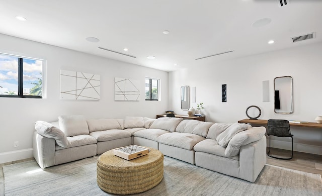 living area featuring wood finished floors, recessed lighting, baseboards, and visible vents