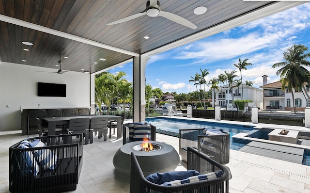 view of patio featuring a fire pit, area for grilling, ceiling fan, and an outdoor pool