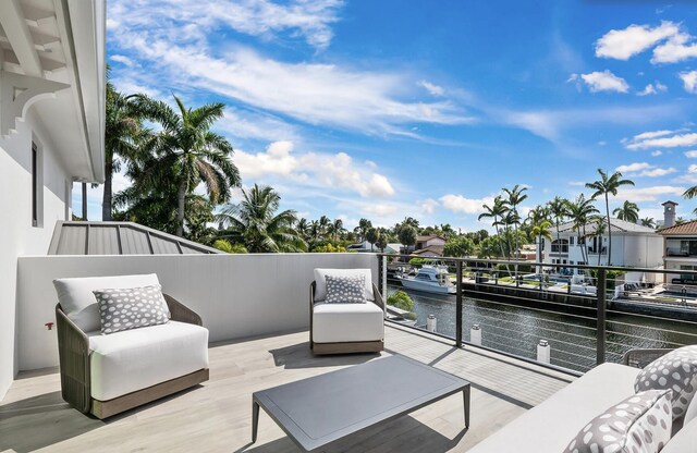 view of patio with a balcony and a water view