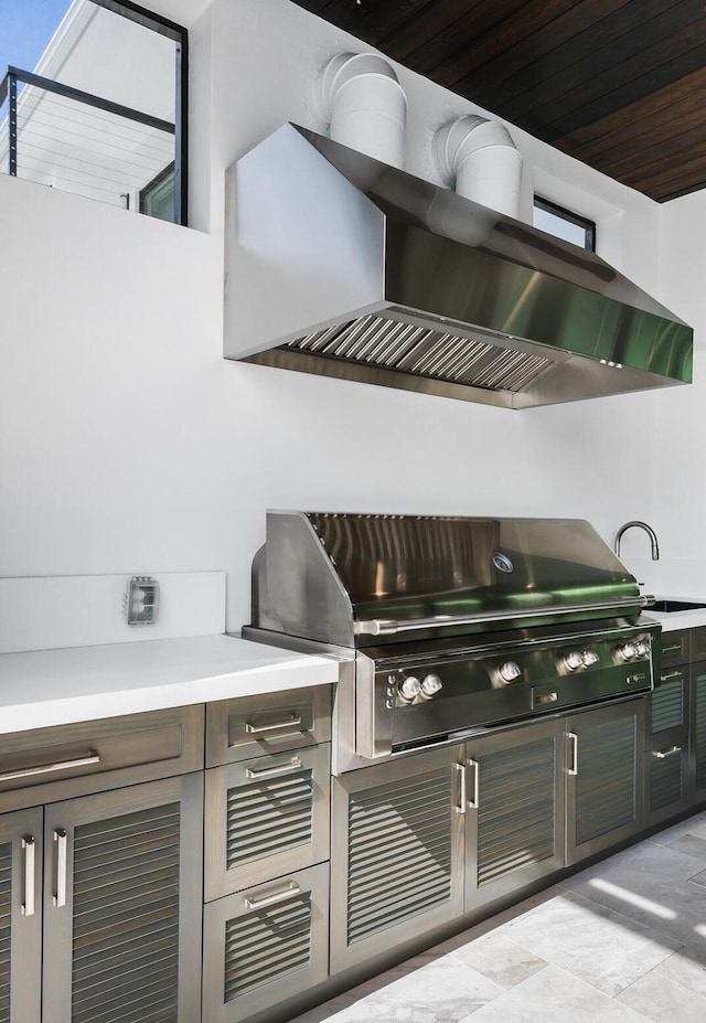 view of patio featuring exterior kitchen, a sink, and grilling area