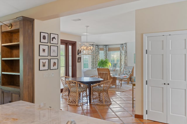 dining room with an inviting chandelier and light tile patterned flooring