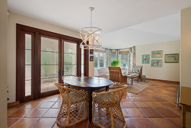 dining area with tile patterned flooring and a notable chandelier