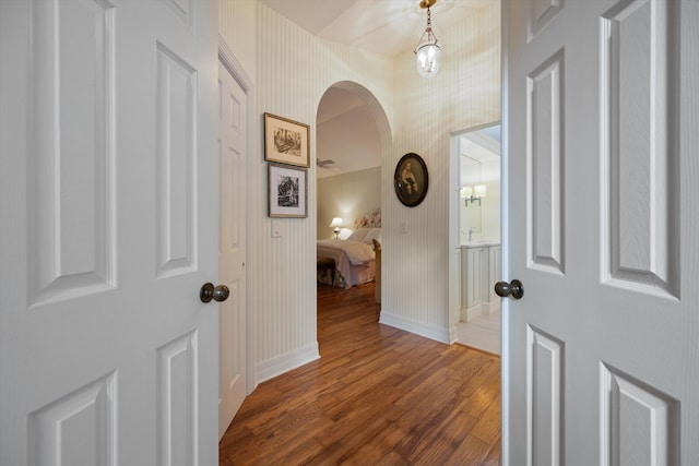 corridor with dark hardwood / wood-style flooring