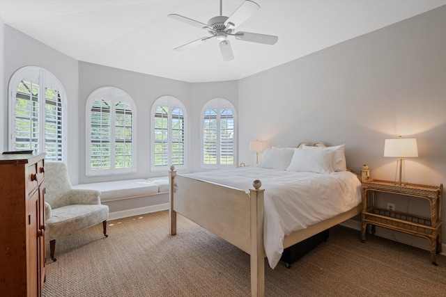 bedroom featuring multiple windows, ceiling fan, and carpet floors