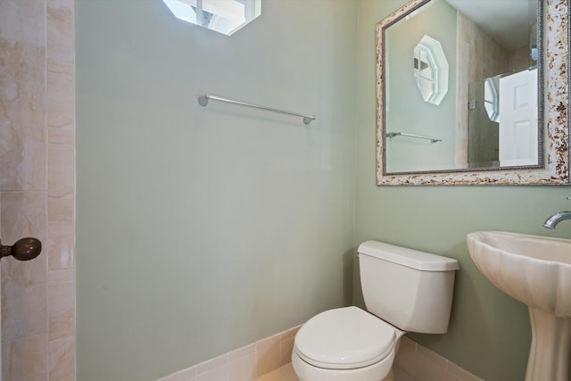 bathroom with sink, plenty of natural light, toilet, and tile patterned floors