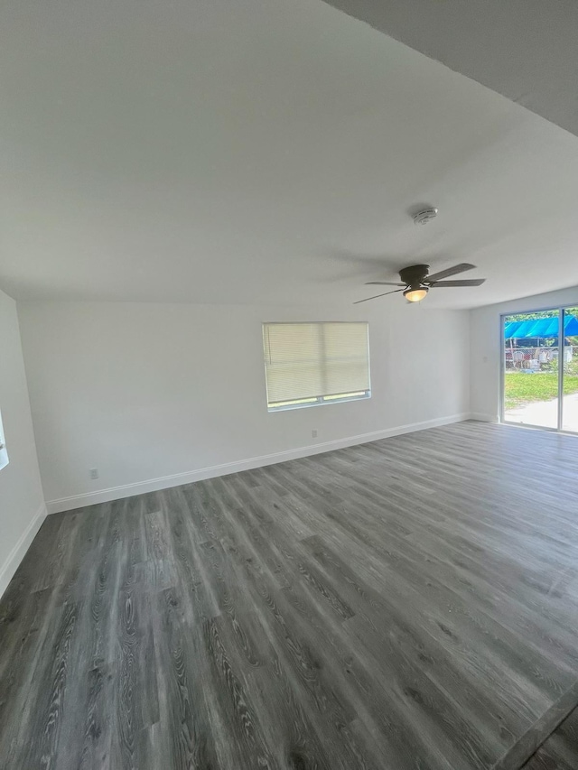 spare room with dark wood-type flooring and ceiling fan