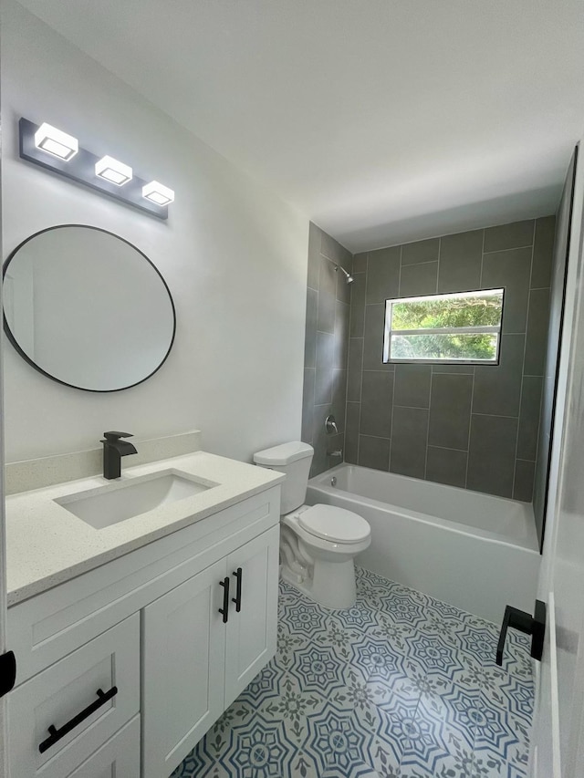 full bathroom with toilet, tiled shower / bath, vanity, and tile patterned flooring