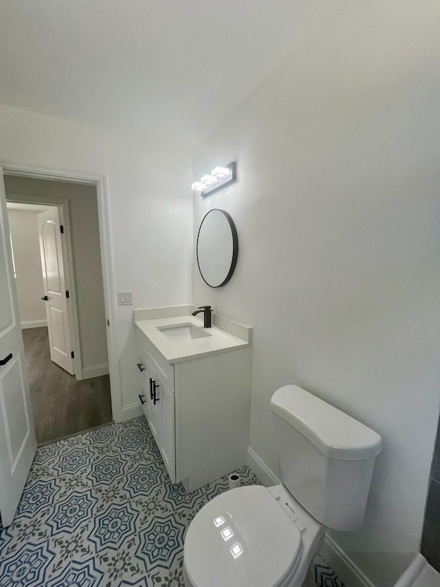 bathroom with vanity, hardwood / wood-style floors, and toilet