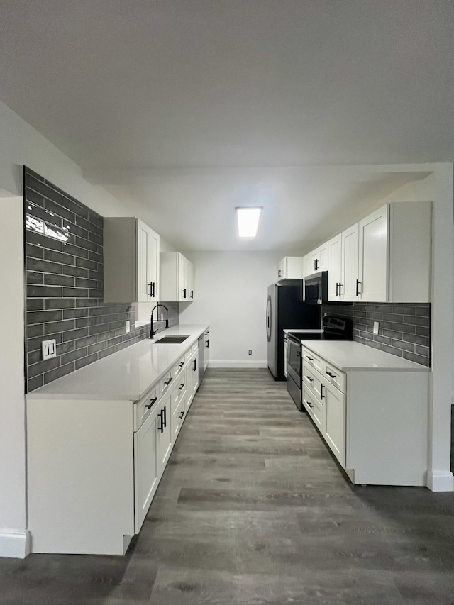 kitchen featuring tasteful backsplash, wood-type flooring, sink, stainless steel appliances, and white cabinets