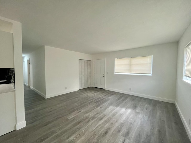 unfurnished living room featuring dark hardwood / wood-style flooring