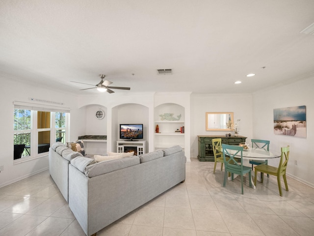 living room featuring ceiling fan, built in features, and light tile patterned floors