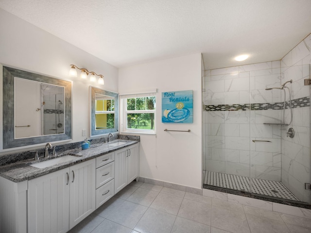 bathroom featuring tile patterned floors, vanity, a textured ceiling, and walk in shower