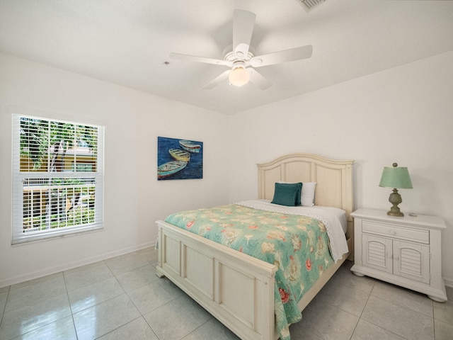 bedroom with ceiling fan and light tile patterned floors