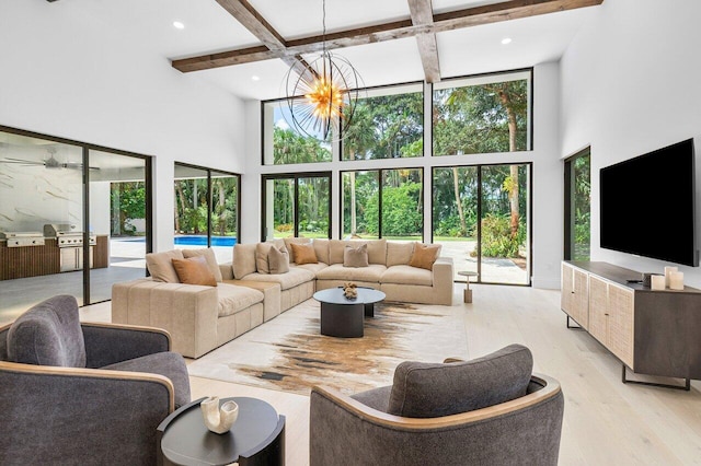 living room featuring beamed ceiling, a towering ceiling, a notable chandelier, and light wood-type flooring