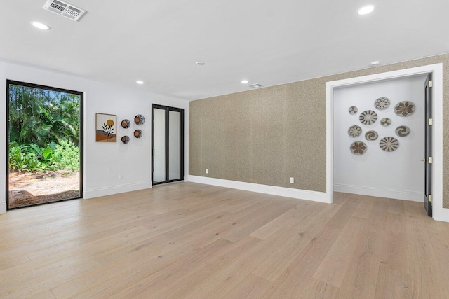 spare room featuring light hardwood / wood-style flooring