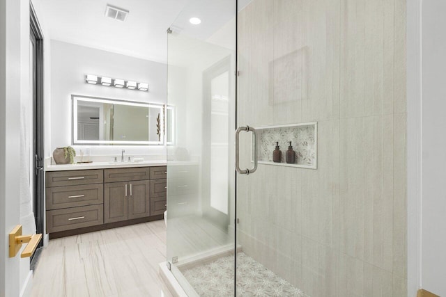 bathroom featuring vanity and an enclosed shower