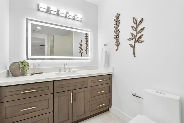 16436 Bridlewood Cir E, Delray Beach, FL 33445 - bathroom featuring vanity, toilet, and baseboards