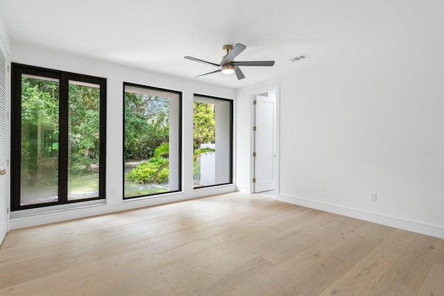 unfurnished room with light wood-type flooring and ceiling fan