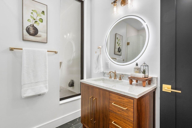 bathroom with vanity and bath / shower combo with glass door