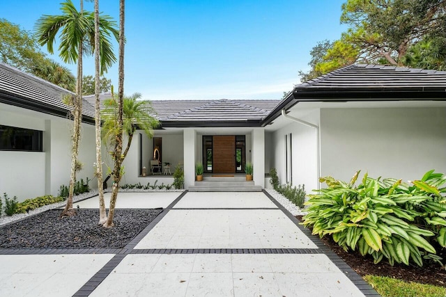 16436 Bridlewood Cir E, Delray Beach, FL 33445 - entrance to property featuring stucco siding, a tiled roof, and a porch