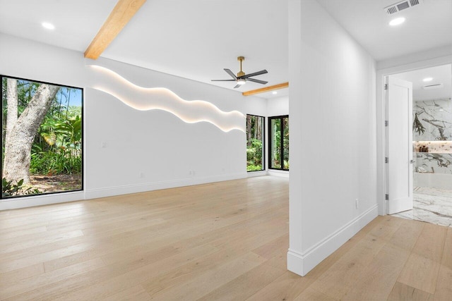 unfurnished living room with ceiling fan, plenty of natural light, and light hardwood / wood-style floors