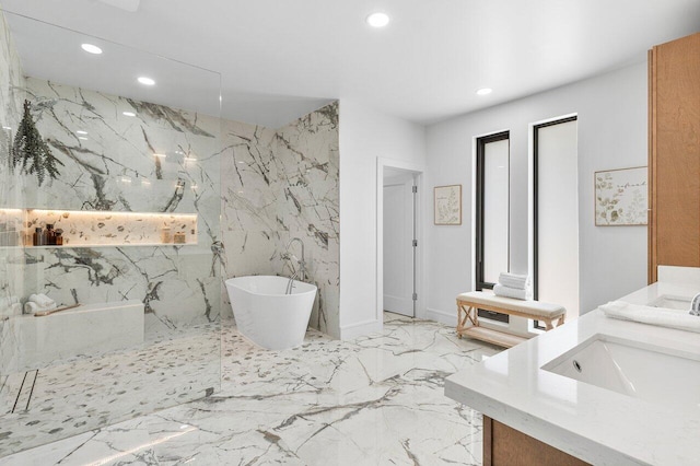 bathroom featuring a shower, vanity, and tile walls