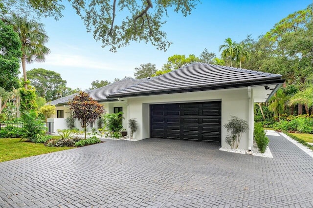 16436 Bridlewood Cir E, Delray Beach, FL 33445 - view of front of house with a garage, decorative driveway, and stucco siding