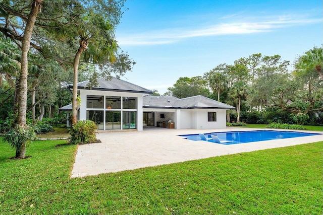 16436 Bridlewood Cir E, Delray Beach, FL 33445 - rear view of house featuring a patio, an outdoor pool, a sunroom, and a lawn
