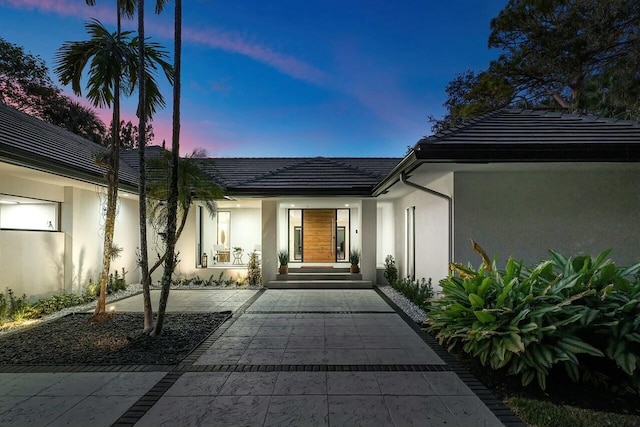 view of exterior entry at dusk