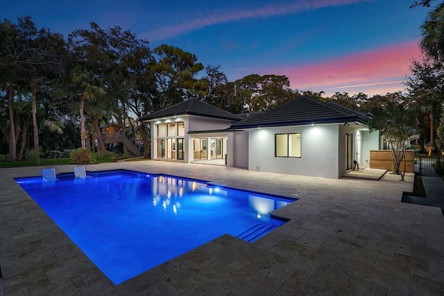 16436 Bridlewood Cir E, Delray Beach, FL 33445 - back of property featuring french doors, stairway, a patio area, stucco siding, and an outdoor pool