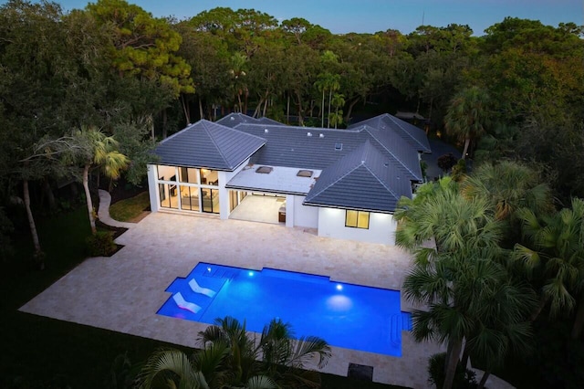 16436 Bridlewood Cir E, Delray Beach, FL 33445 - rear view of property with driveway, a patio, an outdoor pool, and stucco siding