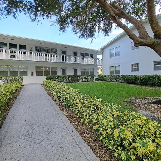 view of property's community with a lawn