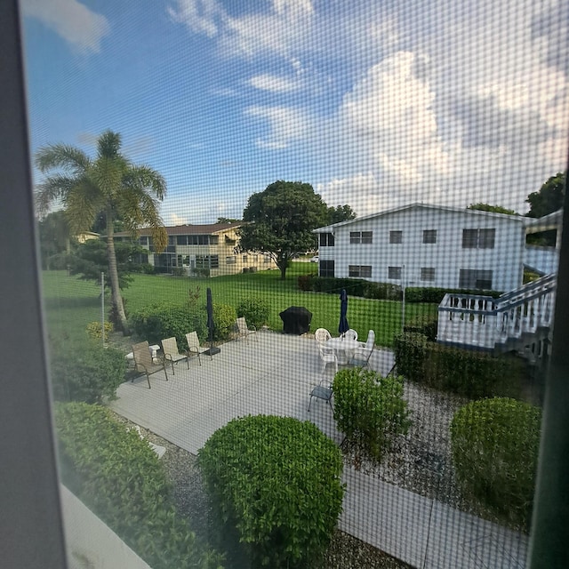 surrounding community featuring a lawn and a patio