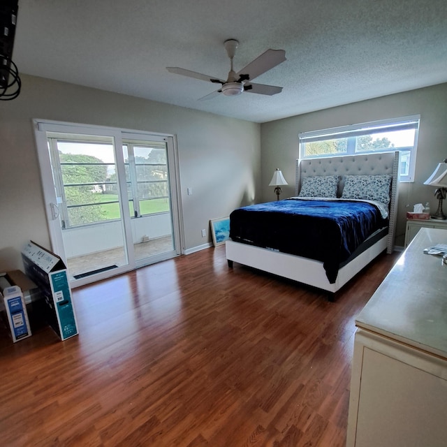 bedroom with a ceiling fan, wood finished floors, baseboards, a textured ceiling, and access to outside