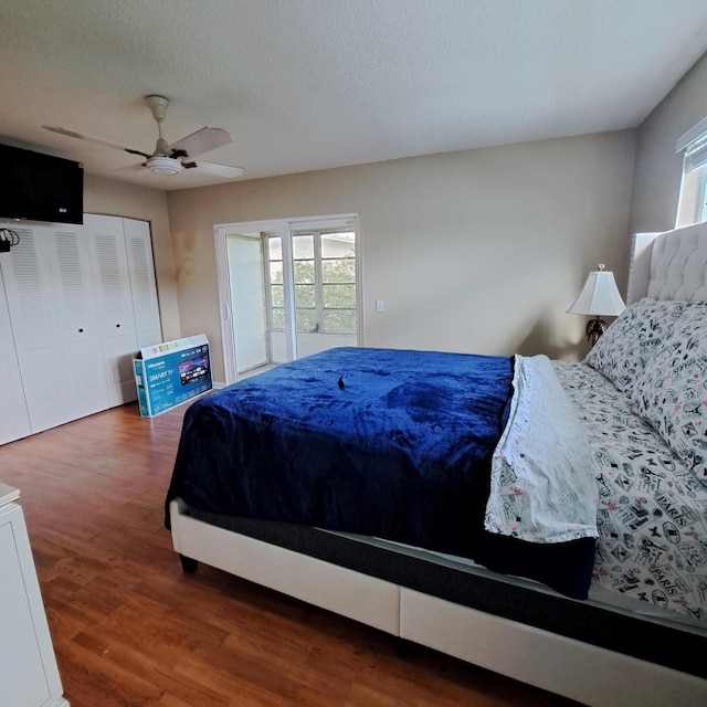 bedroom featuring ceiling fan, a textured ceiling, wood finished floors, and access to exterior