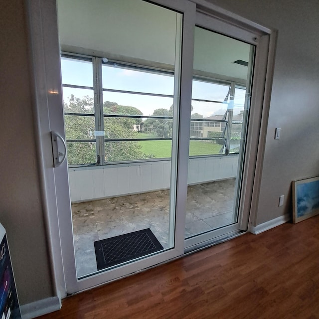 entryway featuring dark wood-type flooring and baseboards