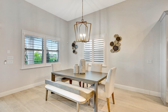 dining area featuring light hardwood / wood-style floors and a chandelier