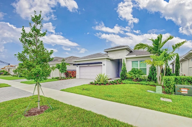 view of front of house featuring a garage and a front yard