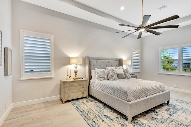 bedroom with ceiling fan and light hardwood / wood-style floors