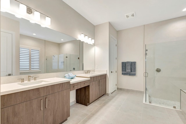 bathroom featuring vanity, tile patterned floors, and walk in shower