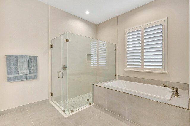 bathroom with tile patterned flooring and plus walk in shower